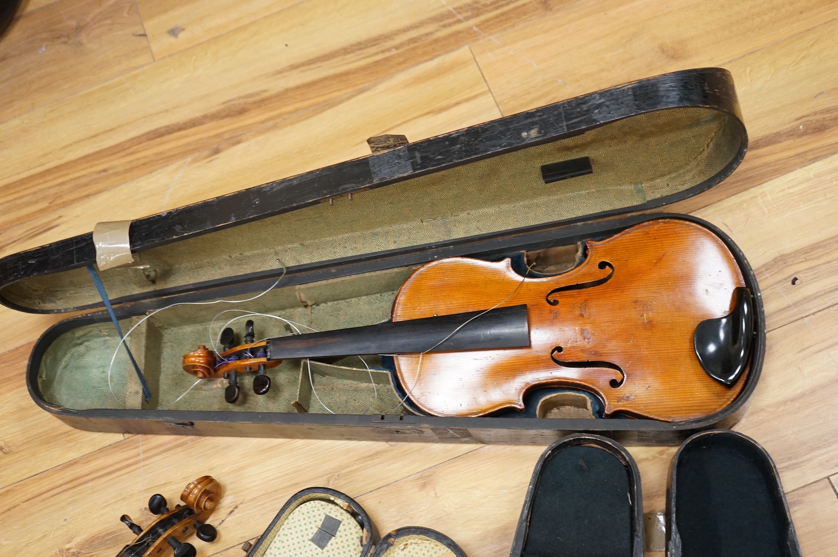 Four violins; a German Dresden violin, together with further two German violins, and a Saxony violin, three in cases or the remains of cases.
